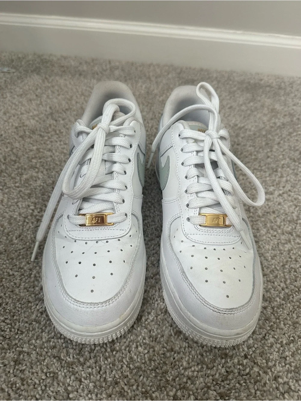 Nike White Sneakers with Sage Green Swoosh and Gold Accent